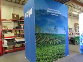 Reconfigurable Island to 10 x 20 Inline with Full-size Closet, Tension Fabric Graphics, (2) Double-sided SuperNova Lightbox, Monitor Mount, Slat Ceiling, and Custom Reception Counter -- View 2